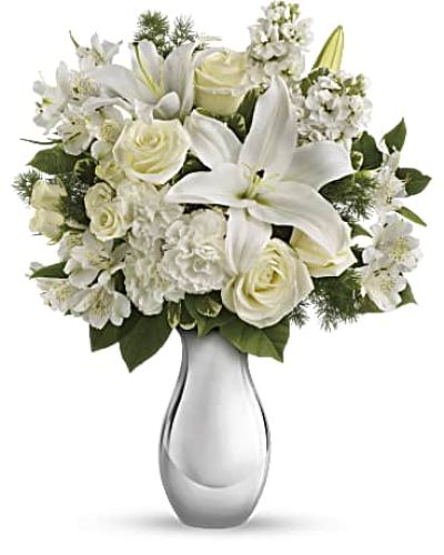 <p>Watching snow fall softly, silently is one of life's loveliest experiences. And the feeling is stirred by this enchanting bouquet of serenely beautiful white flowers in an exquisite glass vase. Give someone you love a whiter Christmas.<br />
The stunning bouquet includes white roses, white spray roses, white oriental lilies, white alstroemeria and white stock accented with assorted greenery.</p>